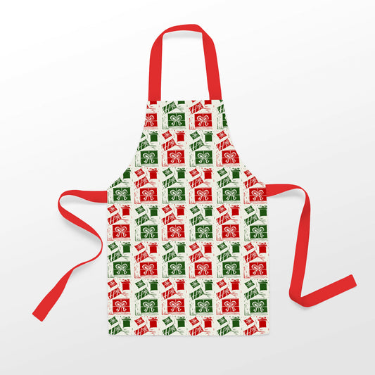 Introducing the Rustic County's Jolly Holiday Gifts Apron, adorned with festive artwork! This delightful apron features a pattern of red and green gift boxes topped with bows, capturing the essence of the holiday spirit. It boasts vibrant red straps and is elegantly set against a light background.