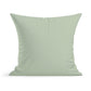 A square, light green Little Birds Pillow by Rustic County with a smooth, slightly wrinkled fabric serves as a whimsical accent for any nursery decor. The pillow is set against a plain, white background.