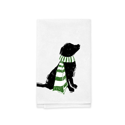 Silhouette of a black lab sitting with its head tilted upward, adorned in a green and white striped scarf against a plain white backdrop—an ideal addition to the Rustic County's Winter Tail Wags Kitchen Tea Towel collection.