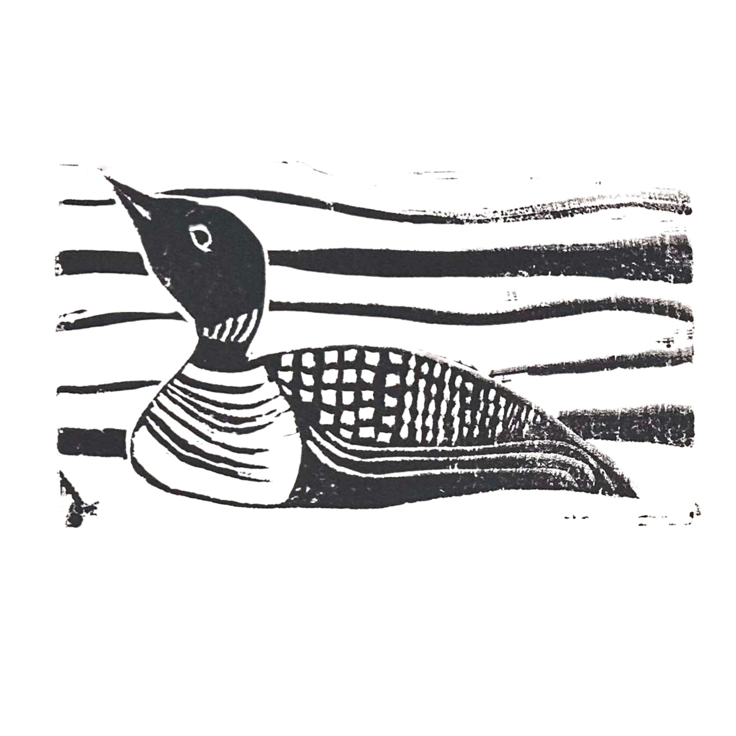 A hand-carved black and white illustration of a loon with a patterned body and striped neck, facing left. The background showcases wavy horizontal lines reminiscent of Rustic County's Maine Loon Handmade Stamp Art.